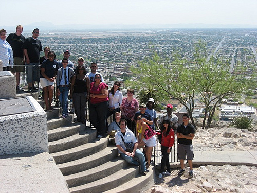 Little children sitting on the stairs taking a photograph ans they're not centered.