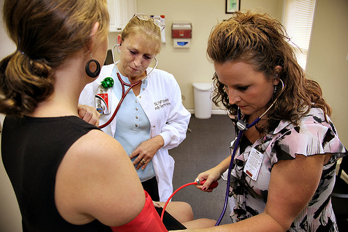 Checking the ladies pulse to verify she is alive.